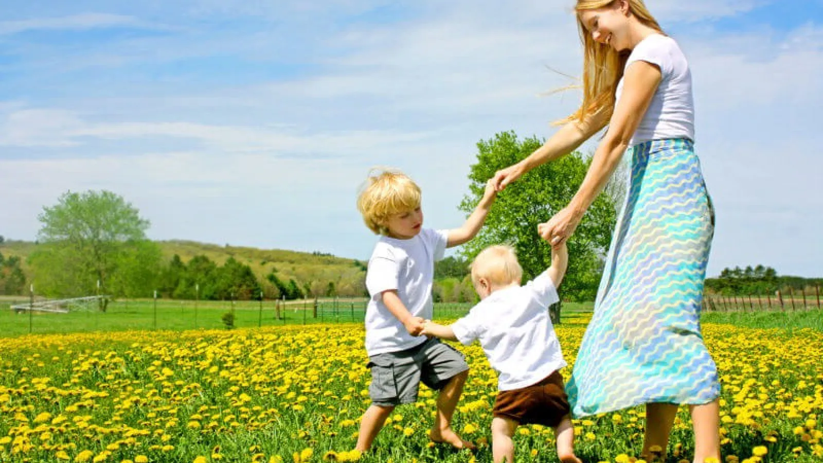 family in a field of dandelions